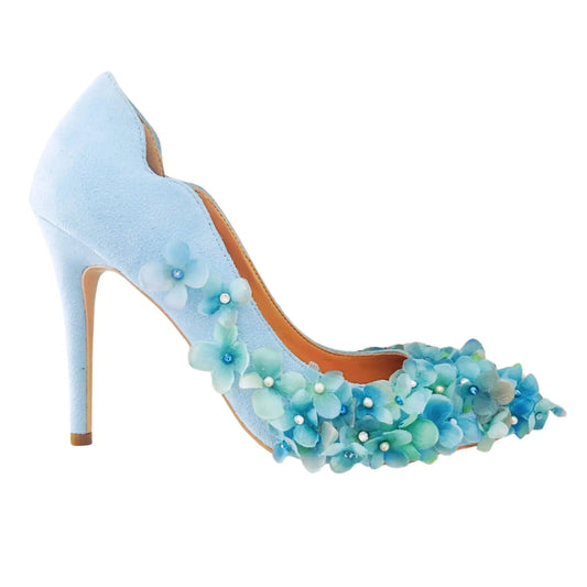 Blue high-heeled shoe with floral decorations on a white background